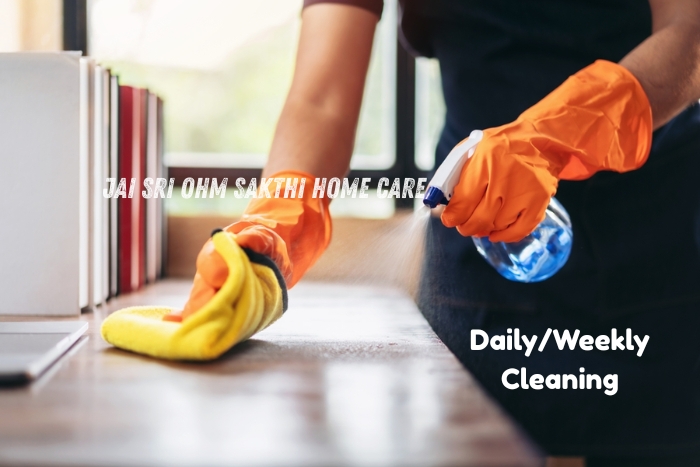 Close-up of a professional cleaner wearing gloves and spraying disinfectant on a table surface-Jai Sri Ohm Sakthi Home